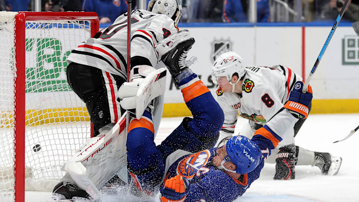 Mar 24, 2026; Elmont, New York, USA; New York Islanders left wing Anders Lee (27) slides into Chicago Blackhawks goaltender Arvid Soderblom (40) after being tripped by Blackhawks center Ryan Donato (8) during the third period at UBS Arena. Mandatory Credit: Brad Penner-Imagn Images
