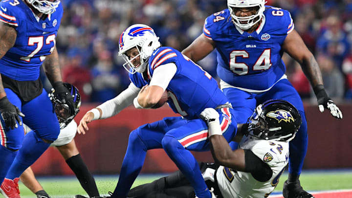 Sep 7, 2025; Orchard Park, New York, USA;  Baltimore Ravens defensive tackle Nnamdi Madubuike (92) tackles Buffalo Bills quarterback Josh Allen (17) during the first quarter at Highmark Stadium. Mandatory Credit: Mark Konezny-Imagn Images