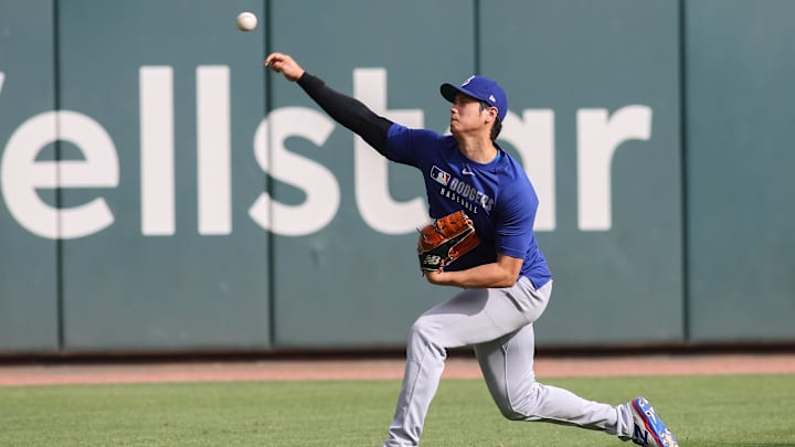 May 2, 2025; Atlanta, Georgia, USA;  Los Angeles Dodgers designated hitter Shohei Ohtani (17) throws before a game against the Atlanta Braves at Truist Park. Mandatory Credit: Brett Davis-Imagn Images