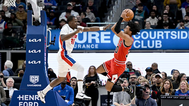 Jan 7, 2026; Detroit, Michigan, USA; Chicago Bulls guard Tre Jones (30) pulls up to shoot the ball over Detroit Pistons guard Javonte Green (31) in the first quarter at Little Caesars Arena. Mandatory Credit: Lon Horwedel-Imagn Images