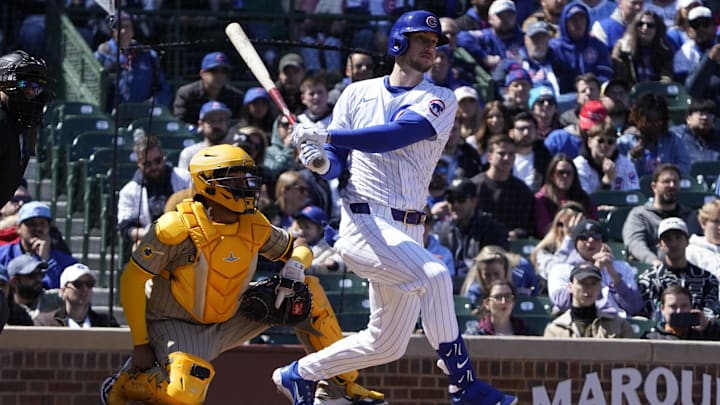 Apr 6, 2025; Chicago, Illinois, USA; Chicago Cubs outfielder Kyle Tucker (30) hits a one run single against the San Diego Padres during the first inning at Wrigley Field. 