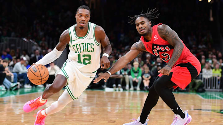 Oct 13, 2024; Boston, Massachusetts, USA; Boston Celtics guard Lonnie Walker IV (12) controls the ball while Toronto Raptors guard Davion Mitchell (45) defends during the first half at TD Garden. Mandatory Credit: Bob DeChiara-Imagn Images Oct 13, 2024; Boston, Massachusetts, USA; Boston Celtics guard Lonnie Walker IV (12) controls the ball while Toronto Raptors guard Davion Mitchell (45) defends during the first half at TD Garden. Mandatory Credit: Bob DeChiara-Imagn Images