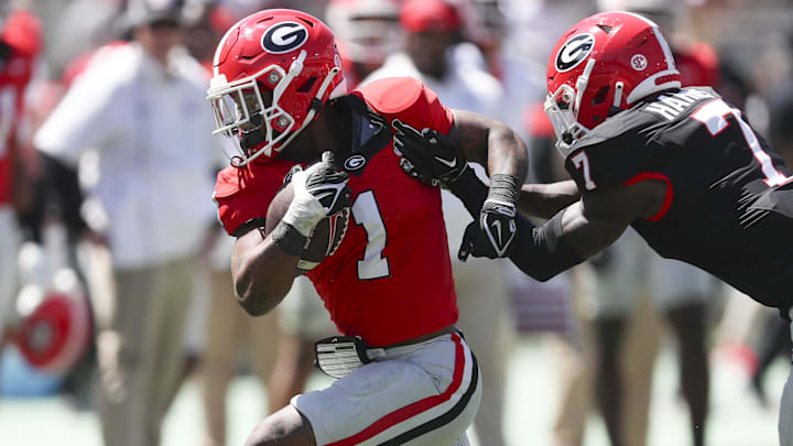 Georgia Bulldogs running back Trevor Etienne (1) gets tackled by defensive back Daniel Harris (7) 