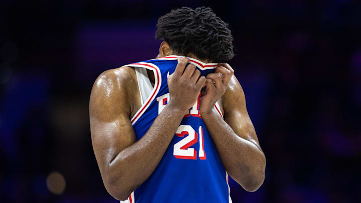 \Philadelphia 76ers center Joel Embiid (21) wipes his face during a break in the third quarter against the Boston Celtics at Wells Fargo Center.