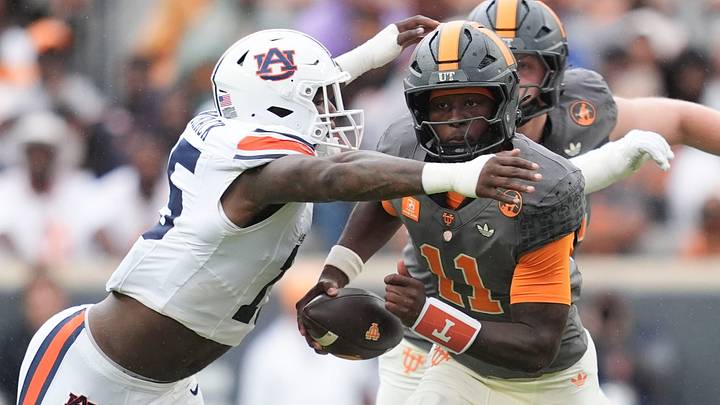 Tennessee quarterback Faizon Brandon (11) carries the ball as Auburn edge Da'Shawn Womack (15) during a college football game on Oct. 3, 2026, in Knoxville, Tennessee.