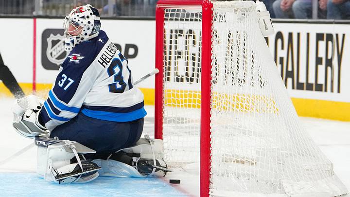 Apr 13, 2026; Las Vegas, Nevada, USA; A shot by Vegas Golden Knights right wing Mark Stone (61) (not pictured) slips across the goal line behind Winnipeg Jets goaltender Connor Hellebuyck (37) during the second period at T-Mobile Arena. Mandatory Credit: Stephen R. Sylvanie-Imagn Images Apr 13, 2026; Las Vegas, Nevada, USA; A shot by Vegas Golden Knights right wing Mark Stone (61) (not pictured) slips across the goal line behind Winnipeg Jets goaltender Connor Hellebuyck (37) during the second period at T-Mobile Arena. Mandatory Credit: Stephen R. Sylvanie-Imagn Images