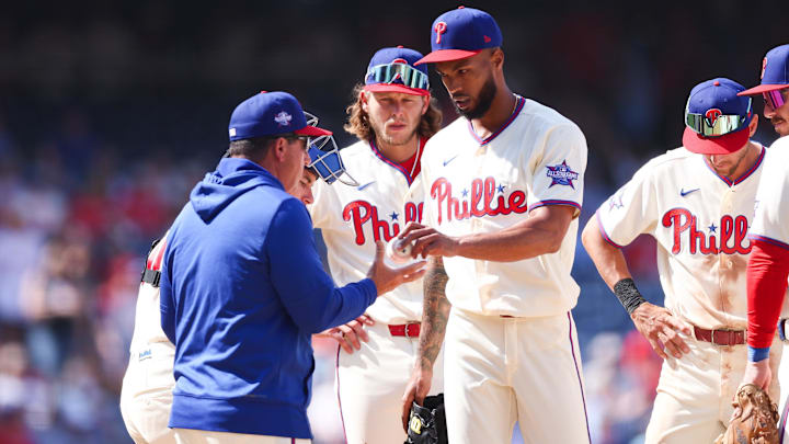 Apr 1, 2026; Philadelphia, Pennsylvania, USA; Philadelphia Phillies pitcher Cristopher Sanchez (61) hands the ball to manager Rob Thomson (blue shirt) in a game against the Washington Nationals at Citizens Bank Park.
