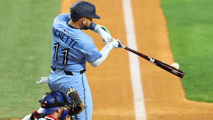 May 28, 2025; Arlington, Texas, USA; Toronto Blue Jays shortstop Bo Bichette (11) hits a two-run home run during the ninth inning against the Texas Rangers at Globe Life Field.