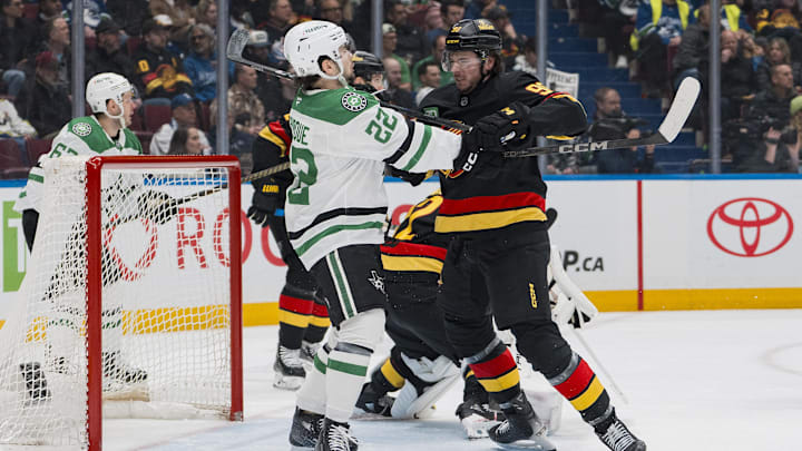 Mar 9, 2025; Vancouver, British Columbia, CAN; Vancouver Canucks defenseman Vittorio Mancini (90) battles with Dallas Stars forward Mavrik Bourque (22) in the first period at Rogers Arena. Mandatory Credit: Bob Frid-Imagn Images
