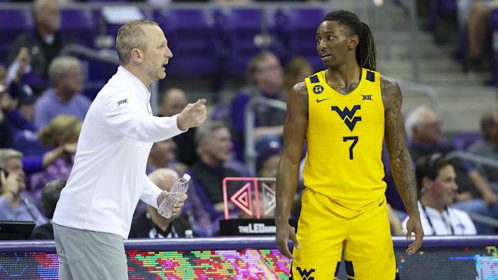 Feb 5, 2025; Fort Worth, Texas, USA; West Virginia Mountaineers guard Javon Small (7) speaks with West Virginia Mountaineers head coach Darian DeVries during the second half against the TCU Horned Frogs at Ed and Rae Schollmaier Arena.