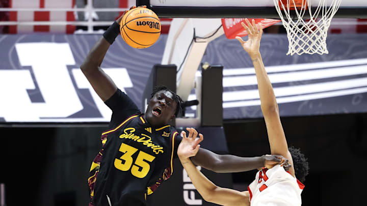 Feb 4, 2026; Salt Lake City, Utah, USA; Arizona State Sun Devils center Massamba Diop (35) takes a pass in the key as Utah Utes forward Josh Hayes (7) defends during the second half at Jon M. Huntsman Center. Mandatory Credit: Rob Gray-Imagn Images