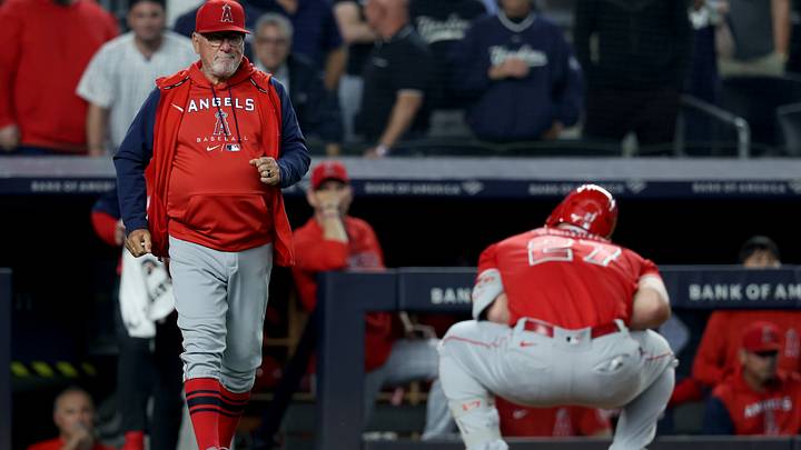 Los Angeles Angels manager Joe Maddon checks on center fielder Mike Trout.