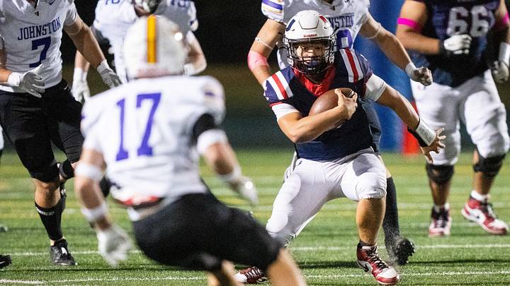 Urbandale's Landon Rinnan (5) runs the ball forward against Johnston on Friday, Oct. 18, 2024, at Frerichs Field in Urbandale. Urbandale's Landon Rinnan (5) runs the ball forward against Johnston on Friday, Oct. 18, 2024, at Frerichs Field in Urbandale.