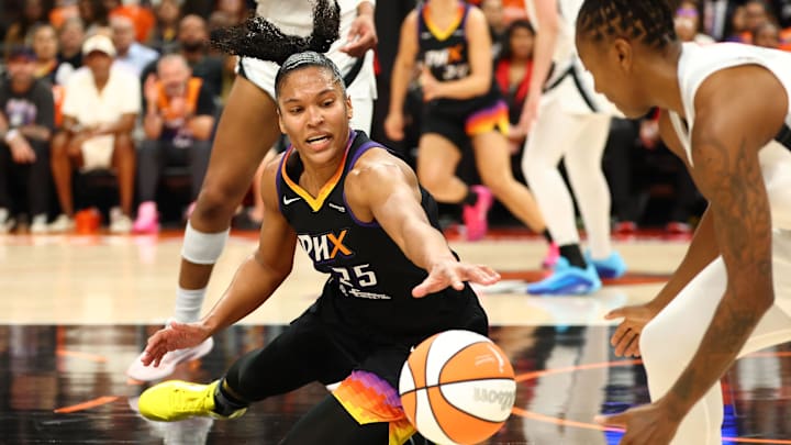 Oct 8, 2025; Phoenix, Arizona, USA; Phoenix Mercury forward Alyssa Thomas (25) dives for a loose ball against the Las Vegas Aces in the first half during game three of the 2025 WNBA Finals at PHX Arena. Mandatory Credit: Mark J. Rebilas-Imagn Images