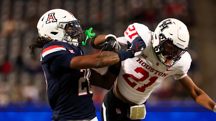 Nov 15, 2024; Tucson, Arizona, USA; Arizona Wildcats defensive back Marquis Groves-Killebrew (20) shoves Houston Cougars running back Stacy Sneed (21) during the third quarter at Arizona Stadium. Mandatory Credit: Aryanna Frank-Imagn Images
