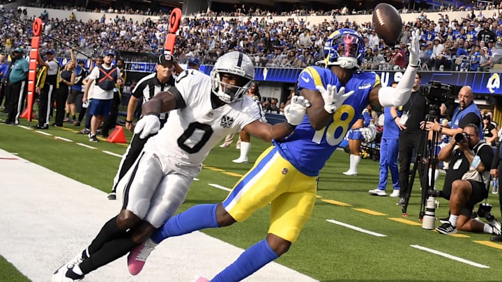Oct 20, 2024; Inglewood, California, USA; Los Angeles Rams wide receiver Tyler Johnson (18) eyes the ball against Las Vegas Raiders cornerback Jakorian Bennett (0) to attempt to catch the ball during the second half at SoFi Stadium. Mandatory Credit: Alex Gallardo-Imagn Images