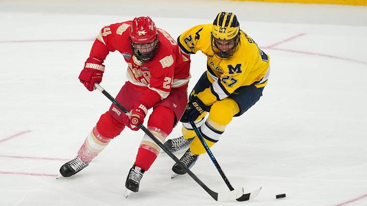 Apr 9, 2026; Las Vegas, Nevada, UNITED STATES; Denver Pioneers forward Kieran Cebrian and Michigan Wolverines forward Malcolm Spence battle for the puck in the second period in the semifinals of the NCAA men's ice hockey Frozen Four at T-Mobile Arena. Apr 9, 2026; Las Vegas, Nevada, UNITED STATES; Denver Pioneers forward Kieran Cebrian and Michigan Wolverines forward Malcolm Spence battle for the puck in the second period in the semifinals of the NCAA men's ice hockey Frozen Four at T-Mobile Arena.