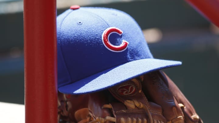 Apr 26, 2015; Cincinnati, OH, USA; A Chicago Cubs hat and glove sits in the dugout during a game with the Cincinnati Reds at Great American Ball Park. Mandatory Credit: David Kohl-Imagn Images