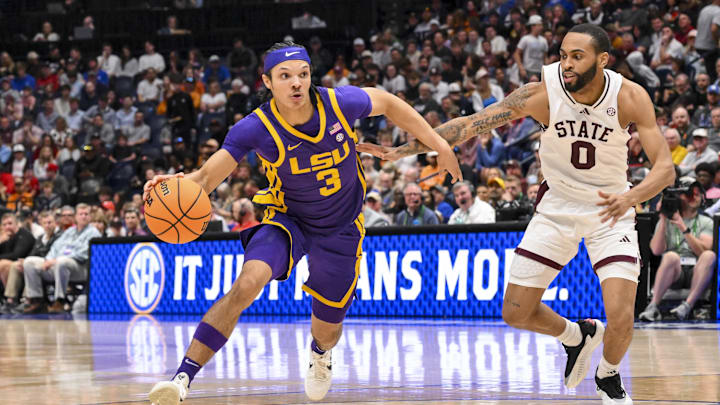 Mar 12, 2025; Nashville, TN, USA; LSU Tigers guard Curtis Givens III (3) dribbles past Mississippi State Bulldogs guard Claudell Harris Jr. (0) during the second half at Bridgestone Arena. Mandatory Credit: Steve Roberts-Imagn Images