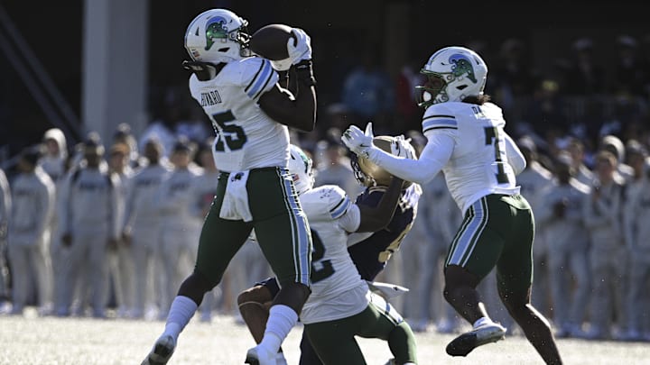 Nov 16, 2024; Annapolis, Maryland, USA;  Tulane Green Wave linebacker Sam Howard (15) catches a Navy Midshipmen tipped pass for a interception during the first half at Navy-Marine Corps Memorial Stadium. 