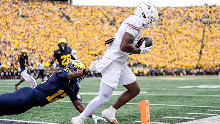 Texas wide receiver Matthew Golden scores a touchdown against Michigan defensive back Aamir Hall during the first half at Michigan Stadium in Ann Arbor 