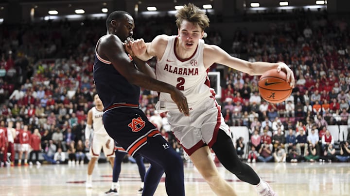 Jan 24, 2024; Tuscaloosa, Alabama, USA;  Auburn Tigers forward Jaylin Williams (2) defends a drive by Alabama Crimson Tide forward Grant Nelson (2) at Coleman Coliseum. Mandatory Credit: Gary Cosby Jr.-Imagn Images