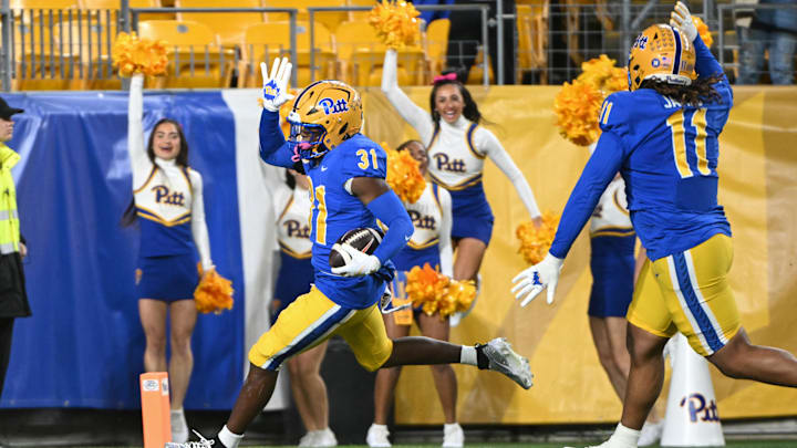 Oct 24, 2024; Pittsburgh, Pennsylvania, USA; Pittsburgh Panthers linebacker Rasheem Biles (31) returns an interception for a touchdown against the Syracuse Orange during the first quarter  at Acrisure Stadium. Mandatory Credit: Barry Reeger-Imagn Images