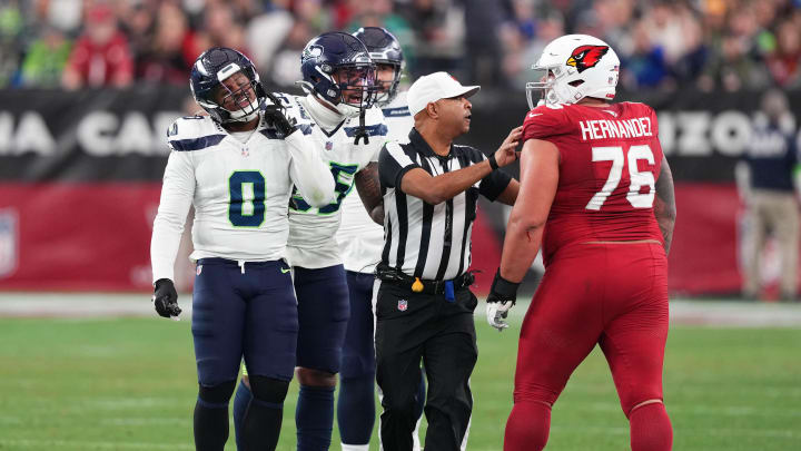 Jan 7, 2024; Glendale, Arizona, USA; Seattle Seahawks linebacker Devin Bush (0) taunts Arizona Cardinals guard Will Hernandez (76) during the second half at State Farm Stadium. Mandatory Credit: Joe Camporeale-USA TODAY Sports