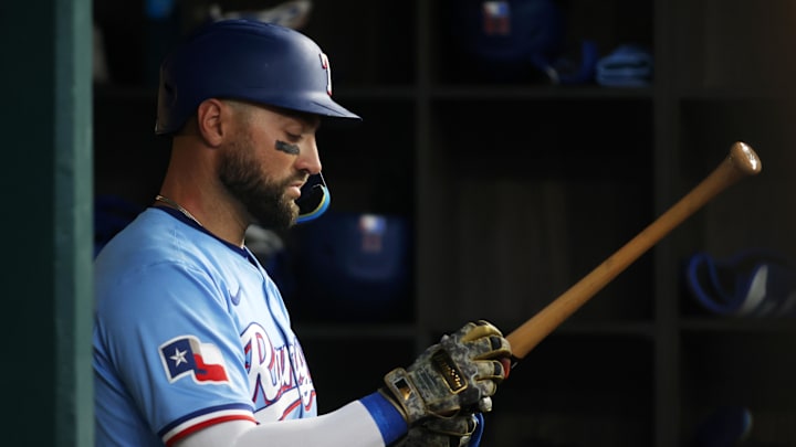 May 18, 2025; Arlington, Texas, USA;  Texas Rangers outfielder Kevin Pillar (1) prepares his bat while in the dugout during the game against the Houston Astros at Globe Life Field. 