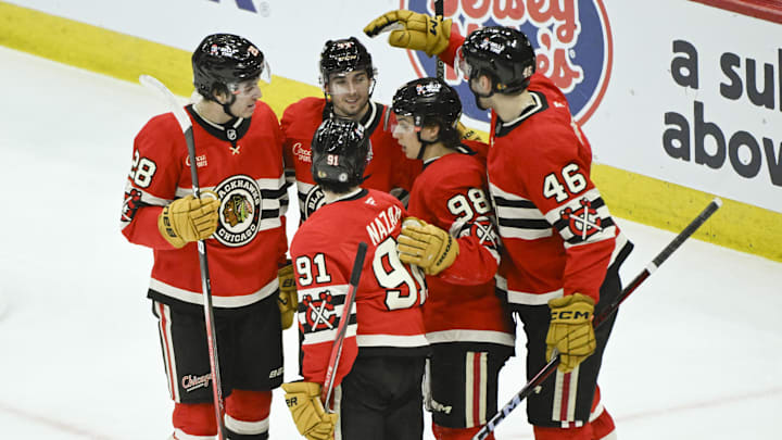 Mar 7, 2025; Chicago, Illinois, USA;  Chicago Blackhawks defenseman Wyatt Kaiser (44) (second from left)  celebrates with teammates after scoring a goal against the Utah Hockey Club during the second period  at the United Center. Mandatory Credit: Matt Marton-Imagn Images