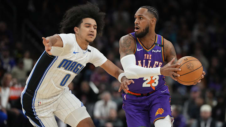 Nov 18, 2024; Phoenix, Arizona, USA; Phoenix Suns guard Monte Morris (23) drives on Orlando Magic guard Anthony Black (0) during the first half of an NBA game at Footprint Center. Mandatory Credit: Rick Scuteri-Imagn Images Nov 18, 2024; Phoenix, Arizona, USA; Phoenix Suns guard Monte Morris (23) drives on Orlando Magic guard Anthony Black (0) during the first half of an NBA game at Footprint Center. Mandatory Credit: Rick Scuteri-Imagn Images