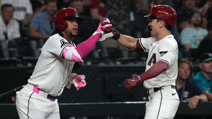Jun 9, 2025; Phoenix, Arizona, USA; Arizona Diamondbacks outfielder Corbin Carroll (7) celebrates with second base Ketel Marte (4) after hitting a solo home run against the Seattle Mariners in the first inning at Chase Field. Mandatory Credit: Rick Scuteri-Imagn Images