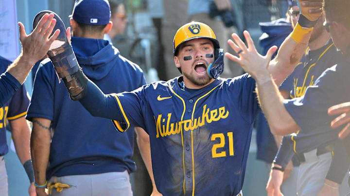 Oct 16, 2025; Los Angeles, California, USA; Milwaukee Brewers third baseman Caleb Durbin (21) celebrates in the dugout after scoring against the Los Angeles Dodgers in the second inning during game three of the NLCS round for the 2025 MLB playoffs at Dodger Stadium. Mandatory Credit: Jayne Kamin-Oncea-Imagn Images