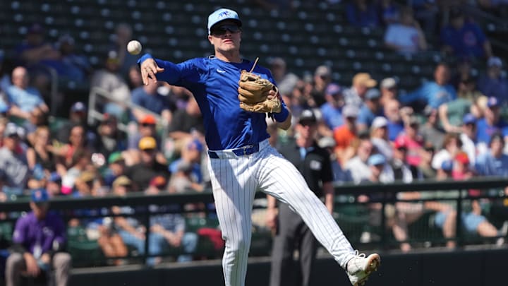 Mar 4, 2025; Mesa, Arizona, USA; Chicago Cubs third baseman Matt Shaw makes the off balance throw for an out against the San Diego Padres in the second inning at Sloan Park.