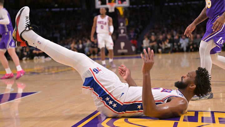 Feb 5, 2026; Los Angeles, California, USA;  Philadelphia 76ers center Joel Embiid (21) lands on the floor after a basket in the first half against the Los Angeles Lakers at Crypto.com Arena. Mandatory Credit: Jayne Kamin-Oncea-Imagn Images