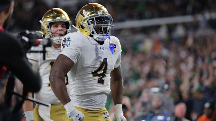 Jan 9, 2025; Miami, FL, USA; Notre Dame Fighting Irish running back Jeremiyah Love (4) celebrates a touch down in the second half against the Penn State Nittany Lions in the Orange Bowl at Hard Rock Stadium. Mandatory Credit: Sam Navarro-Imagn Images