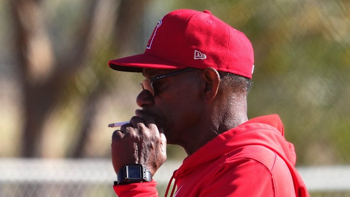 Feb 16, 2024; Tempe, AZ, USA; Los Angeles Angels manager Ron Washington smokes a cigarette during a