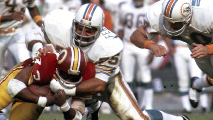 Miami Dolphins defensive tackle Manny Fernandez (75) tackles Washington Redskins running back Larry Brown (43) in Super Bowl VII at the Los Angeles Coliseum.