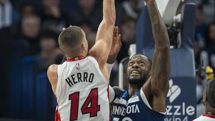 Nov 10, 2024; Minneapolis, Minnesota, USA; Miami Heat guard Tyler Herro (14) shoots the ball over Minnesota Timberwolves forward Julius Randle (30) in the first half at Target Center. 