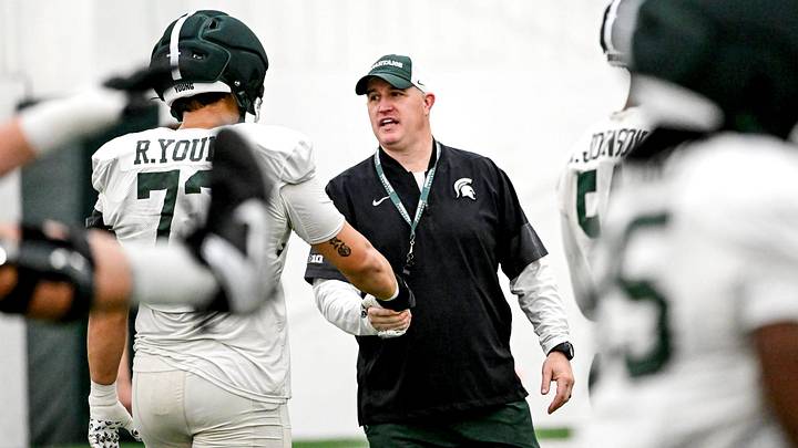 Michigan State's head coach Pat Fitzgerald, right, talks with Rustin Young during spring football practice on Tuesday, April 14, 2026, in East Lansing. Michigan State's head coach Pat Fitzgerald, right, talks with Rustin Young during spring football practice on Tuesday, April 14, 2026, in East Lansing.