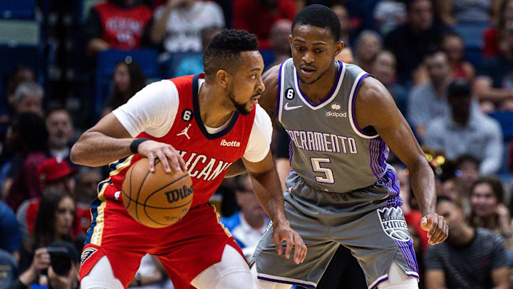 Apr 4, 2023; New Orleans, Louisiana, USA;  New Orleans Pelicans guard CJ McCollum (3) dribbles the ball against Sacramento Kings guard De'Aaron Fox (5) during the first half at Smoothie King Center. 