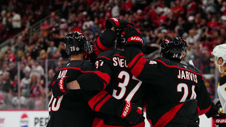 Oct 31, 2024; Raleigh, North Carolina, USA;  Carolina Hurricanes right wing Andrei Svechnikov (37) celebrates his goal with center Sebastian Aho (20) and center Seth Jarvis (24) during the first period against the Boston Bruins during the first period at Lenovo Center. Mandatory Credit: James Guillory-Imagn Images