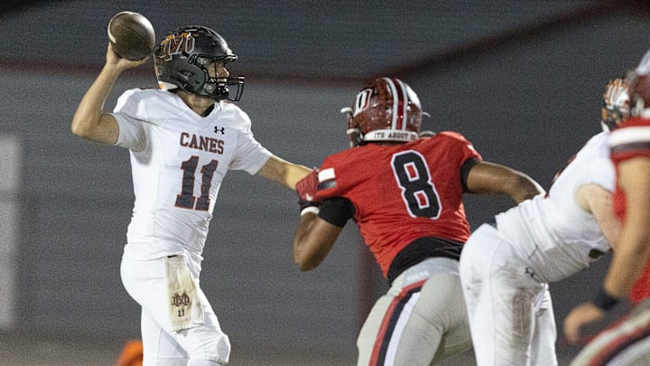 Mount Dora quarterback Jake Sepe (11) gets pressure from Dunnellon Kaiden Robinson-Vickers (8) during a 3A FHSAA playoff game at Dunnellon High School in Dunnellon. Mount Dora quarterback Jake Sepe (11) gets pressure from Dunnellon Kaiden Robinson-Vickers (8) during a 3A FHSAA playoff game at Dunnellon High School in Dunnellon.