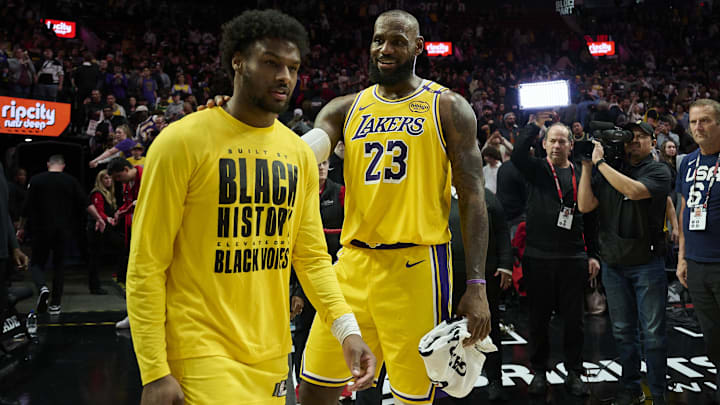 Los Angeles Lakers forward LeBron James (23) celebrates victory over the Portland Trail Blazers with his son guard Bronny James (9) at Moda Center.