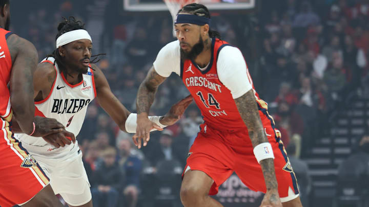 Oct 27, 2024; Portland, Oregon, USA;  New Orleans Pelicans forward Brandon Ingram (14) drives on Portland Trail Blazers forward Jerami Grant (9) in the first half at Moda Center. Mandatory Credit: Jaime Valdez-Imagn Images