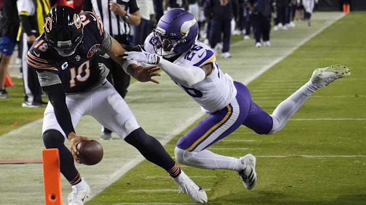 Caleb Williams reaches for the pylon as Vikings safety Theo Jackson tries to prevent a touchdown at Soldier Field in the season opener.