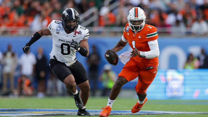 Dec 28, 2024; Orlando, FL, USA; Miami Hurricanes quarterback Cam Ward (1) runs with the ball against the Iowa State Cyclones in the second quarter during the Pop Tarts bowl at Camping World Stadium. Mandatory Credit: Nathan Ray Seebeck-Imagn Images Dec 28, 2024; Orlando, FL, USA; Miami Hurricanes quarterback Cam Ward (1) runs with the ball against the Iowa State Cyclones in the second quarter during the Pop Tarts bowl at Camping World Stadium. Mandatory Credit: Nathan Ray Seebeck-Imagn Images