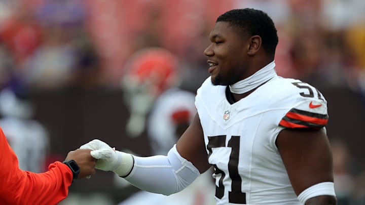 Cleveland Browns defensive tackle Mike Hall Jr. (51) shakes hands with a coach before an NFL preseason football game at Cleveland Browns Stadium, Saturday, Aug. 17, 2024, in Cleveland, Ohio.