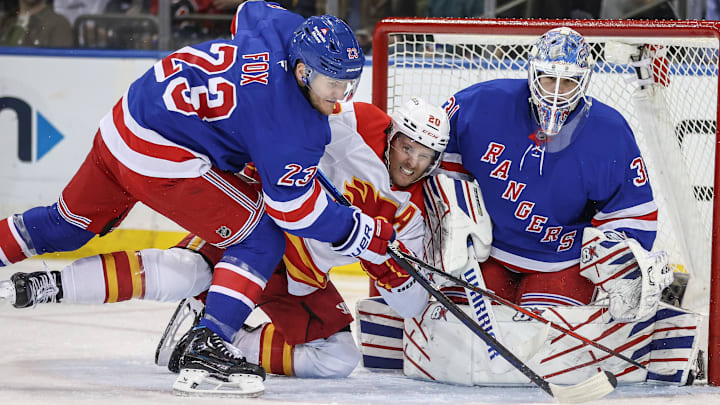 Mar 18, 2025; New York, New York, USA;  New York Rangers goaltender Igor Shesterkin (31) defends the net as  defenseman Adam Fox (23) and Calgary Flames left wing Blake Coleman (20) battle for control of the puck in the second period at Madison Square Garden. Mandatory Credit: Wendell Cruz-Imagn Images