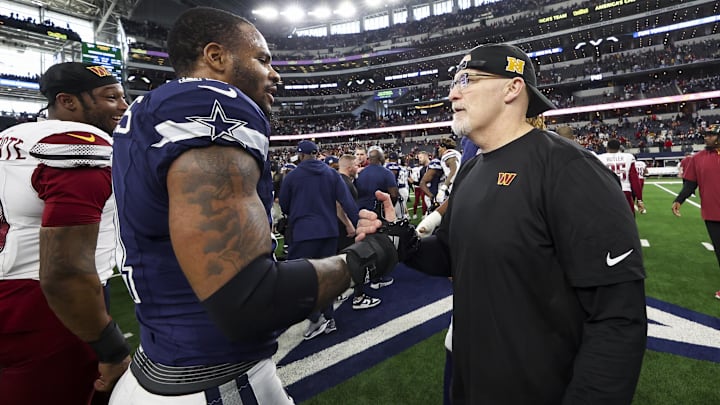 Dallas Cowboys linebacker Micah Parsons speaks with Washington Commanders head coach Dan Quinn.